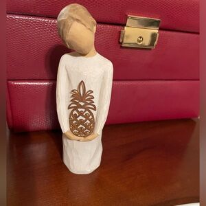 Willow Tree “Gracious” figurine holding a pineapple.